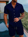 Man in a dark blue short sleeve shirt and shorts set
