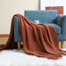 Caramel net knit throw on a blue armchair