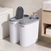 Bathroom setting with two gray trash cans and a bottle of diffuser.
